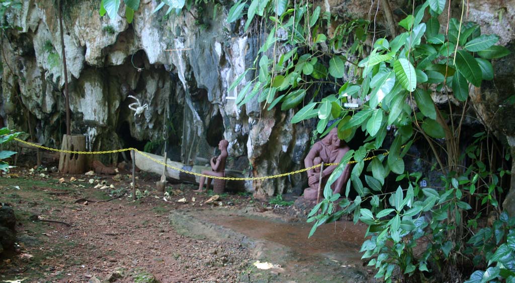 To the left of the entrance.