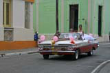 Camagüey: the girl standing up in the Chevy Impala might have been enjoying her quinceañera, a celebration for the coming of age on her 15th birthday.