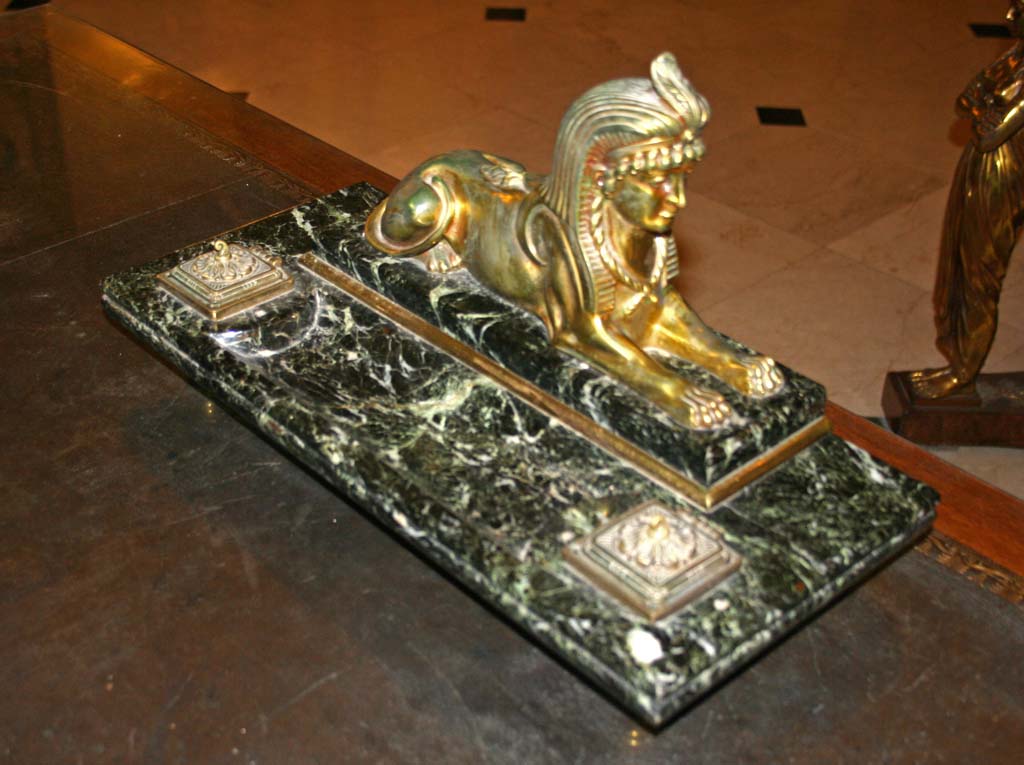 The sphinx paper weight on the desk.